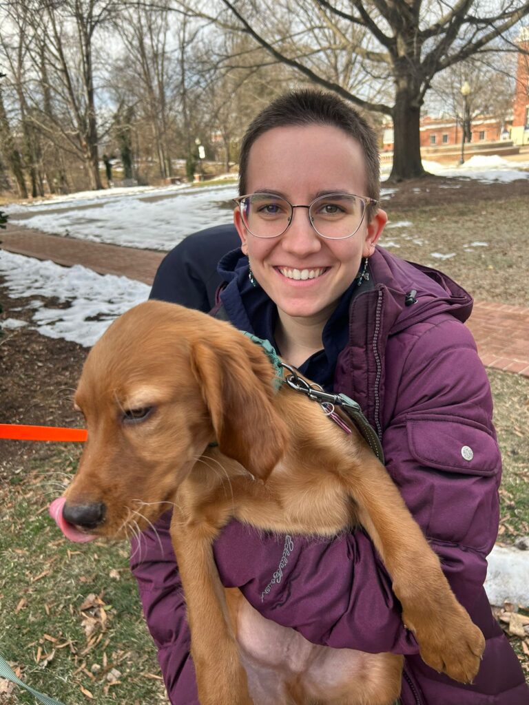 Woman smiling while holding a dog